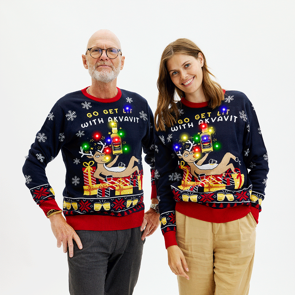 Dunkelblauer Weihnachtspullover Damen mit buntem Weihnachtsmotiv, Schriftzug und roten Bündchen, Acryl.